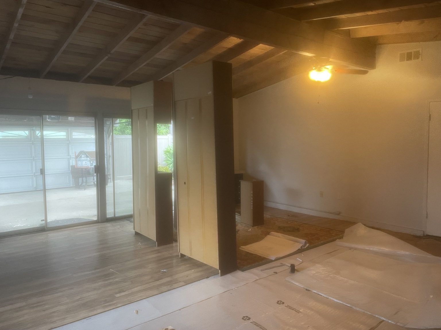 Existing garage interior with old flooring and finishes before demolition