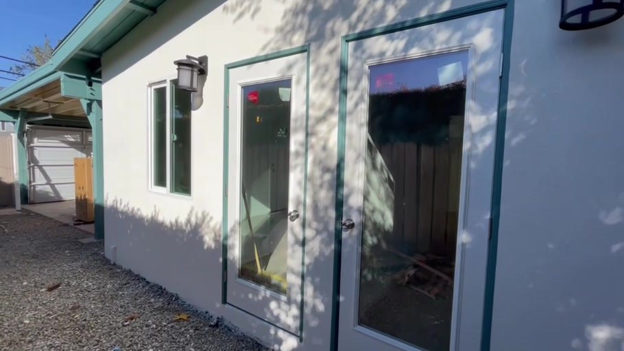 Finished ADU exterior with new stucco and French doors
