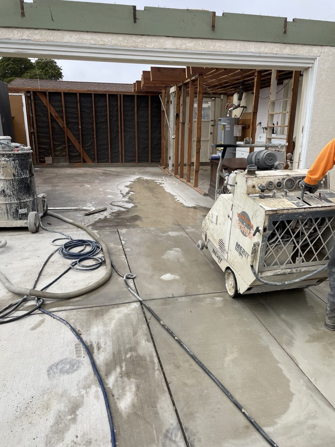 Concrete saw making clean cuts across the driveway