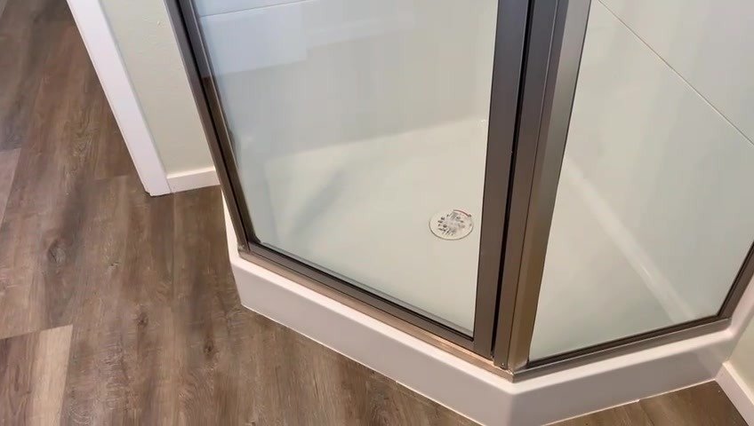 Shower enclosure with LVP flooring