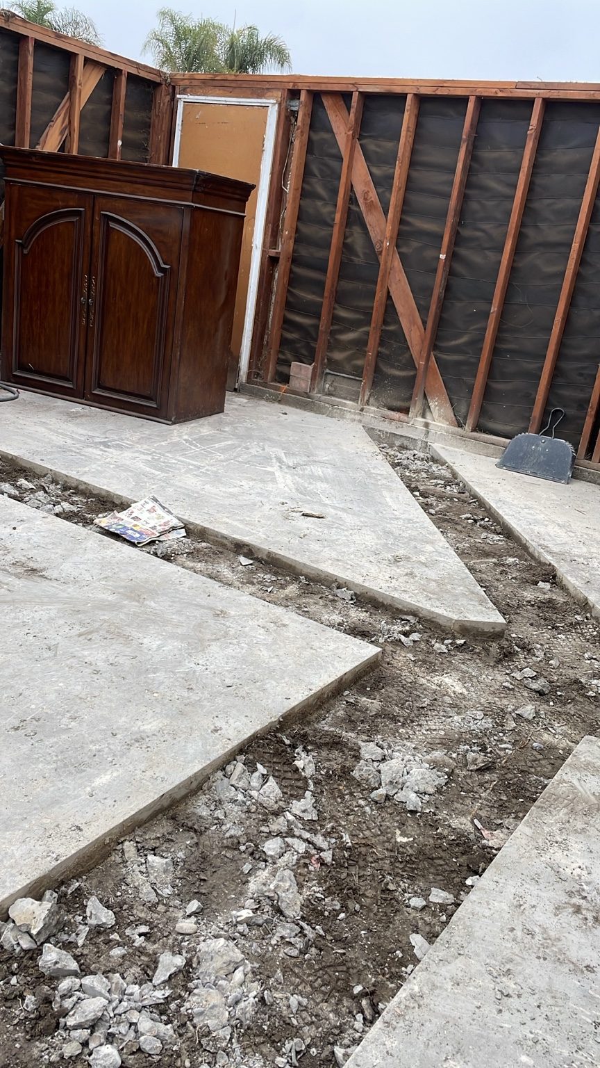 Garage slab saw-cut and removed in strips for new waste lines