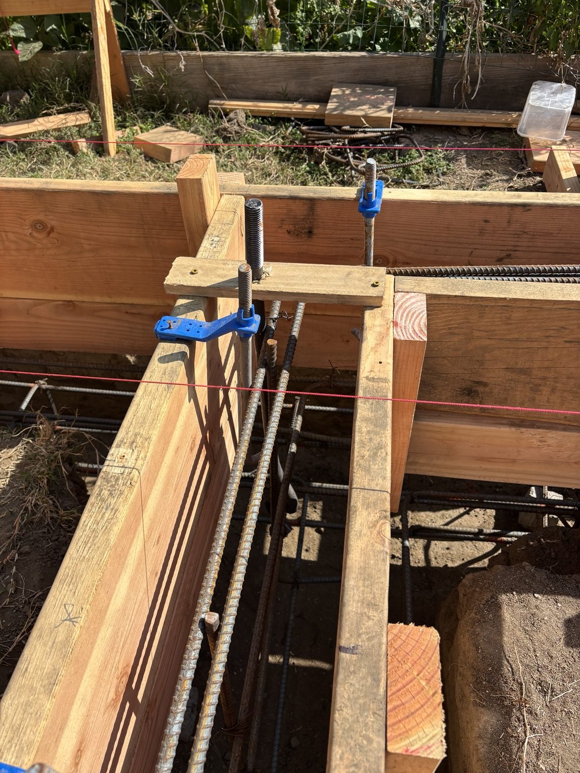 Footing forms with rebar and anchor bolts set for the new foundation