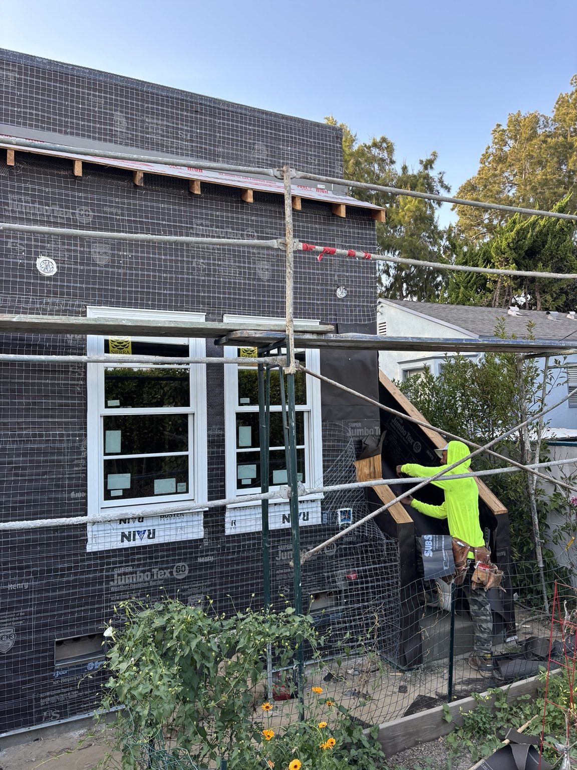 Stucco lath and new windows styled to match the original windows