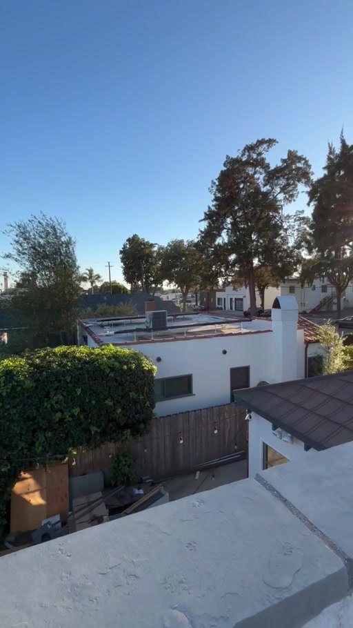 View from the roof deck over a stone-capped parapet wall