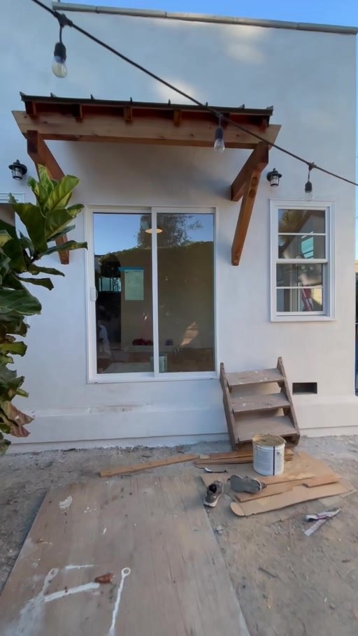 Finished addition exterior with redwood overhang over the entry